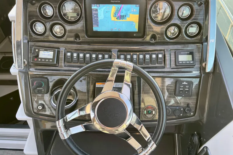Slide: The Image of Dashboard of a 2019 Monterey 295 Sport Yacht with navigation and control instruments. - 17