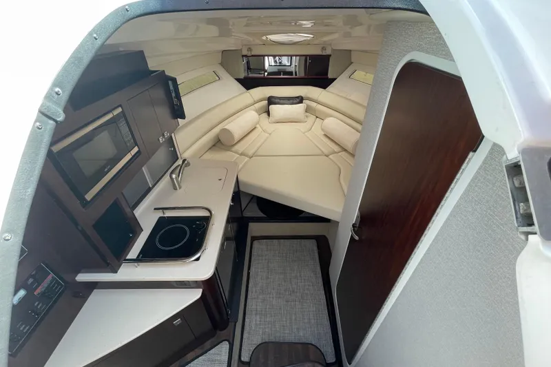Slide: The Image of Interior of 2019 Monterey 295 Sport Yacht with kitchenette and cozy seating area. - 20