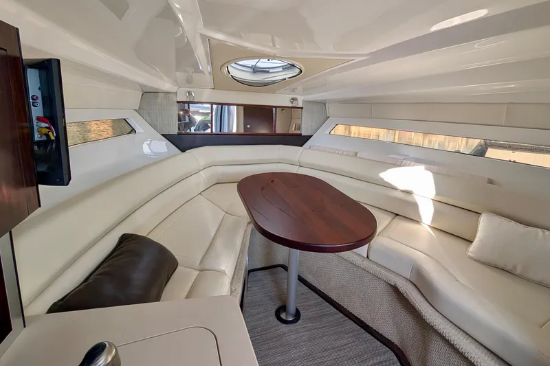 Slide: The Image of Luxurious interior of 2019 Monterey 295 Sport Yacht with elegant seating and wooden table. - 24