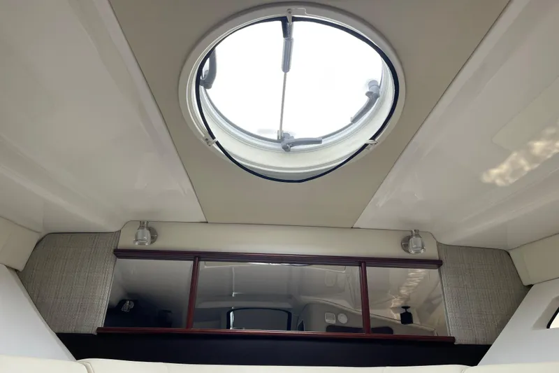 Slide: The Image of Interior view of 2019 Monterey 295 Sport Yacht with circular skylight and modern design. - 26
