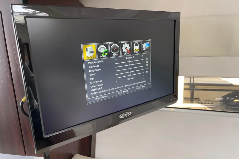Slide: The Image of Jensen TV displaying settings menu inside 2019 Monterey 295 Sport Yacht cabin. - 28