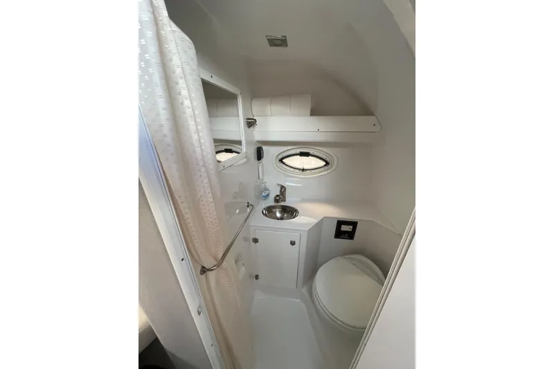 Slide: The Image of Compact bathroom in 2019 Monterey 295 Sport Yacht with sink, toilet, and shower. - 30