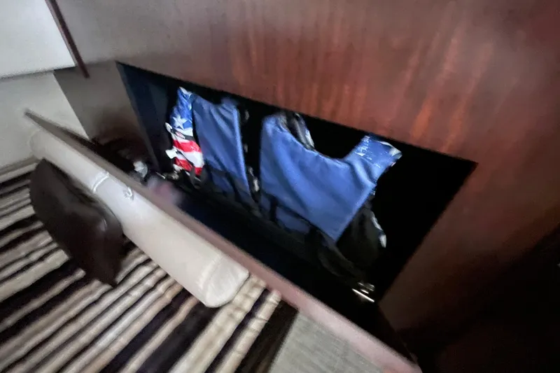 Slide: The Image of Interior storage of 2019 Monterey 295 Sport Yacht with life jackets and striped flooring. - 32
