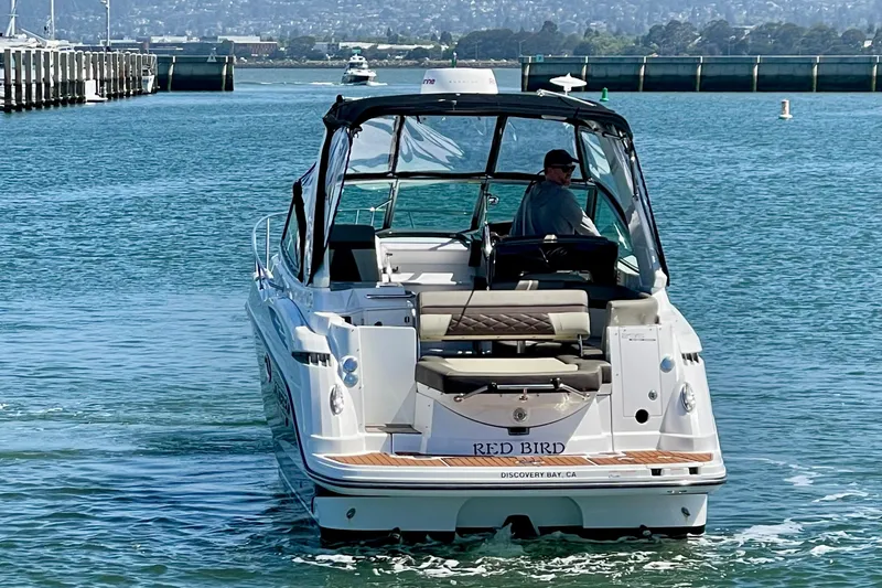 Slide: The Image of 2019 Monterey 295 Sport Yacht cruising in a scenic bay. - 4