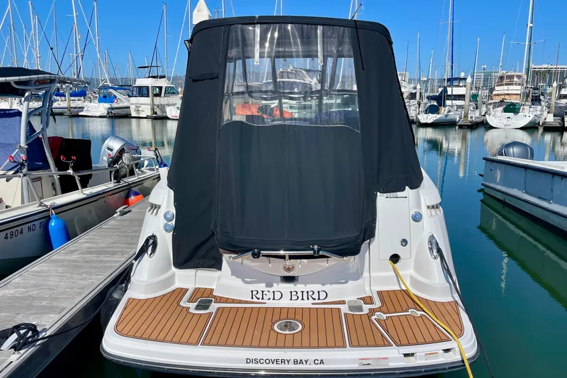 Slide: The Image of 2019 Monterey 295 Sport Yacht docked at marina, featuring "Red Bird" name on stern. - 9