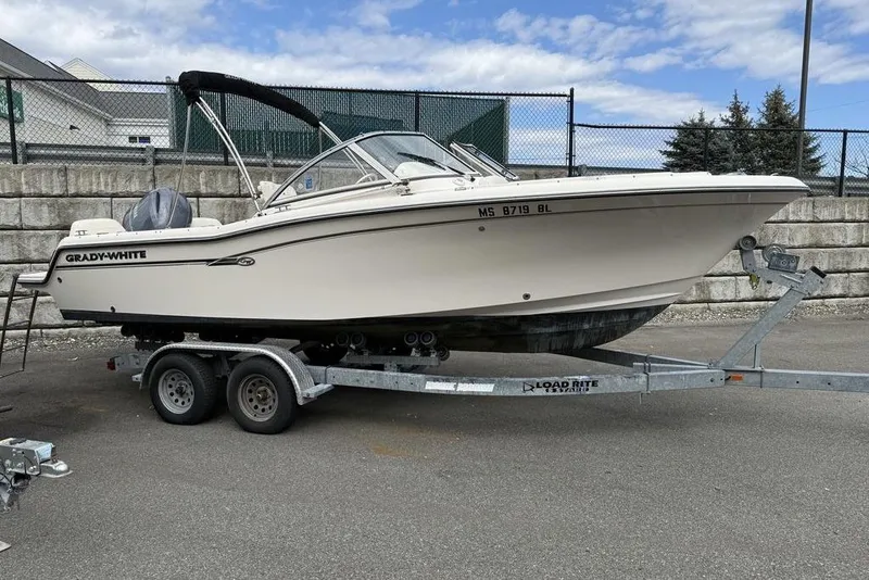 The Image of 2019 Grady-White Freedom 215 boat on trailer, parked outdoors. - 0