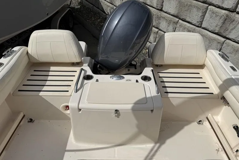 Slide: The Image of 2019 Grady-White Freedom 215 boat interior with seating and engine view. - 15