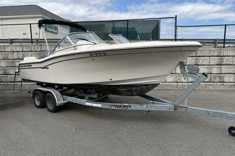 Slide: The Image of 2019 Grady-White Freedom 215 boat on trailer, parked outdoors. - 2