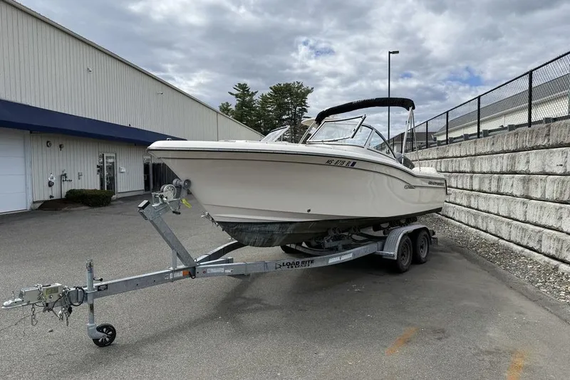 Slide: The Image of 2019 Grady-White Freedom 215 boat on trailer, parked outdoors near a building. - 3