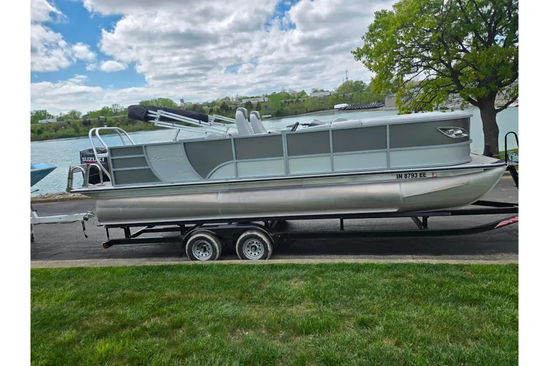Slide: The Image of 2020 Bentley Pontoons 220 Elite Swingback Dual Captain on trailer by a lake. - 10