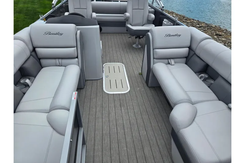 Slide: The Image of 2020 Bentley Pontoons 220 Elite Swingback Dual Captain interior with luxurious seating and lake view. - 11
