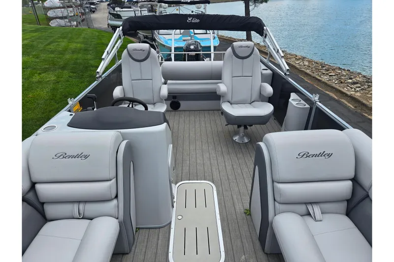 Slide: The Image of 2020 Bentley Pontoons 220 Elite Swingback Dual Captain interior with luxurious seating and steering. - 12