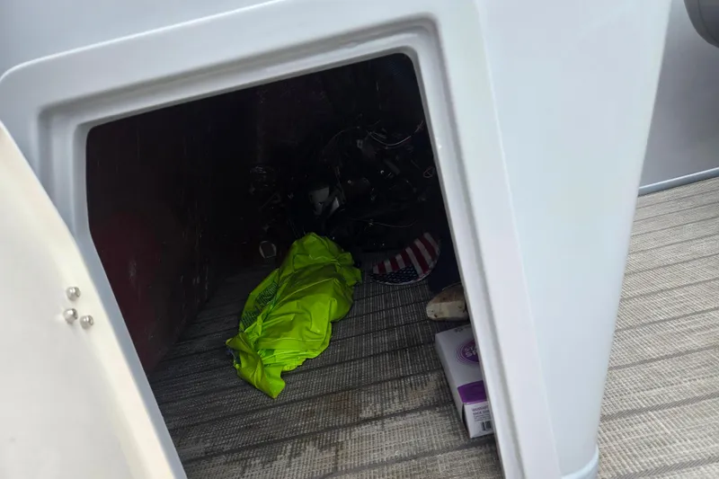 Slide: The Image of Storage compartment of 2020 Bentley Pontoons 220 Elite Swingback, containing a bright green item. - 15