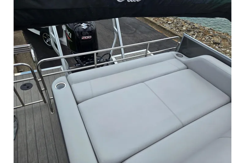 Slide: The Image of 2020 Bentley Pontoons 220 Elite Swingback Dual Captain with Suzuki 200 engine, docked by water. - 18