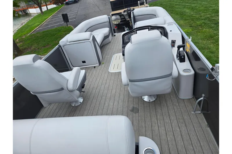 Slide: The Image of 2020 Bentley Pontoons 220 Elite Swingback Dual Captain interior with gray seating and helm. - 21