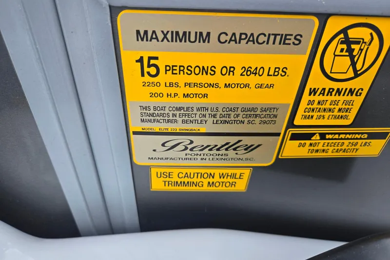 Slide: The Image of 2020 Bentley Pontoons 220 Elite Swingback Dual Captain capacity and safety warning label. - 23