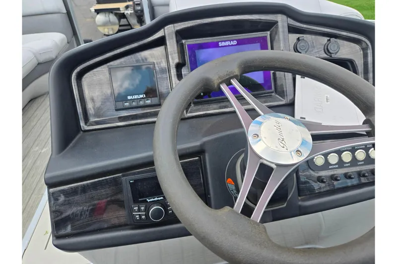 Slide: The Image of 2020 Bentley Pontoons 220 Elite Swingback Dual Captain dashboard with steering wheel and control panel. - 24