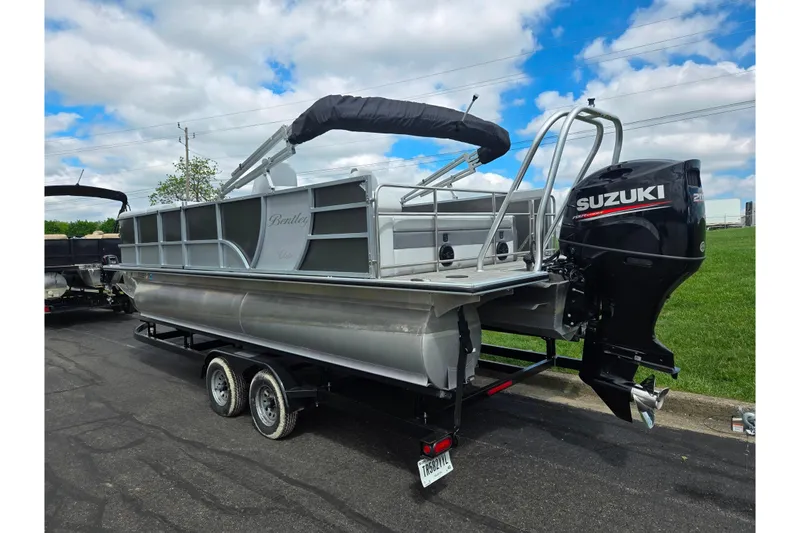 Slide: The Image of 2020 Bentley Pontoons 220 Elite Swingback Dual Captain with Suzuki outboard motor on trailer. - 3