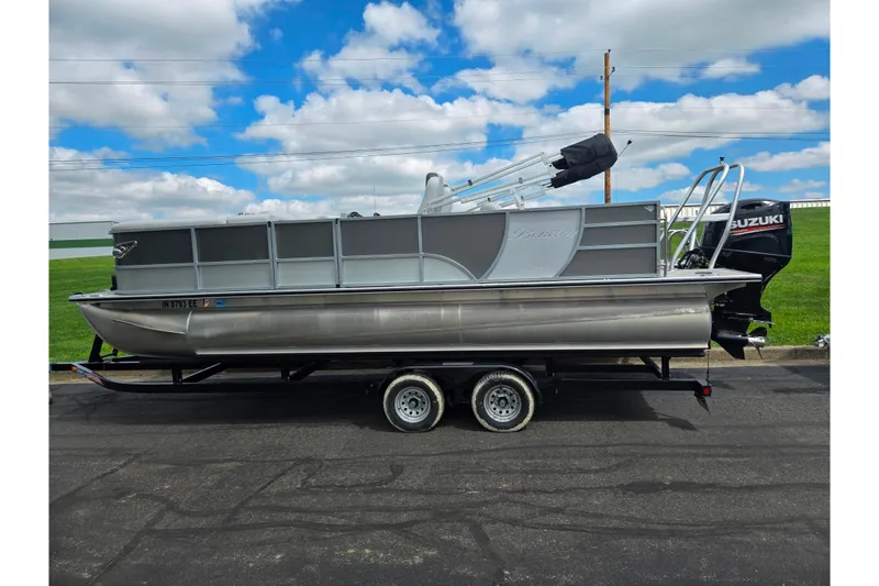 Slide: The Image of 2020 Bentley Pontoons 220 Elite Swingback Dual Captain on trailer, featuring Suzuki outboard motor. - 4