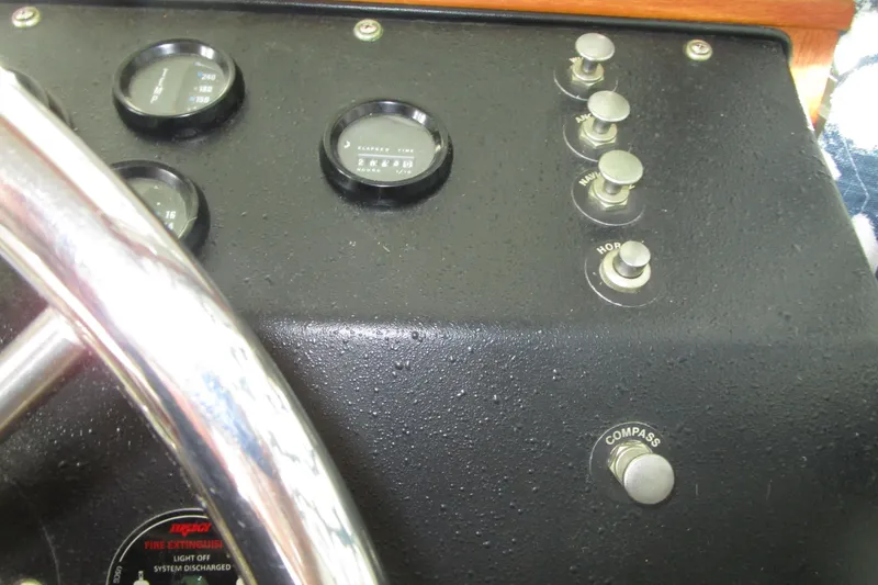 Slide: The Image of Dashboard of a 1984 Tollycraft 26 Sedan boat with gauges and controls. - 10