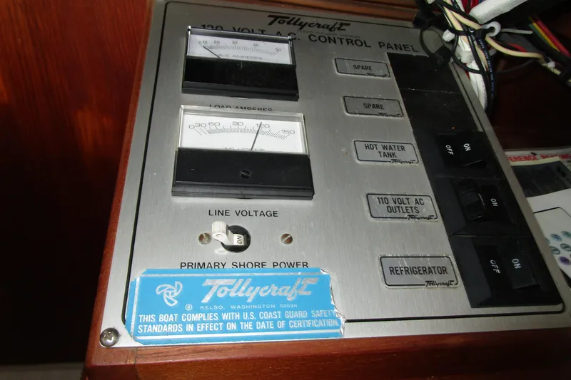 Slide: The Image of Electrical control panel of a 1984 Tollycraft 26 Sedan boat, featuring voltage and amperage gauges. - 11