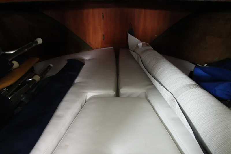 Slide: The Image of Interior cabin view of 1984 Tollycraft 26 Sedan with white cushions and wooden paneling. - 14
