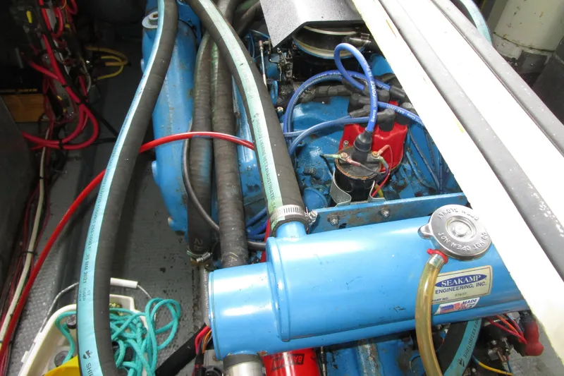 Slide: The Image of Engine compartment of a 1984 Tollycraft 26 Sedan boat, featuring hoses and wiring. - 20