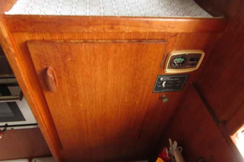 Slide: The Image of 1984 Tollycraft 26 Sedan interior with wooden cabinetry and control panel. - 21
