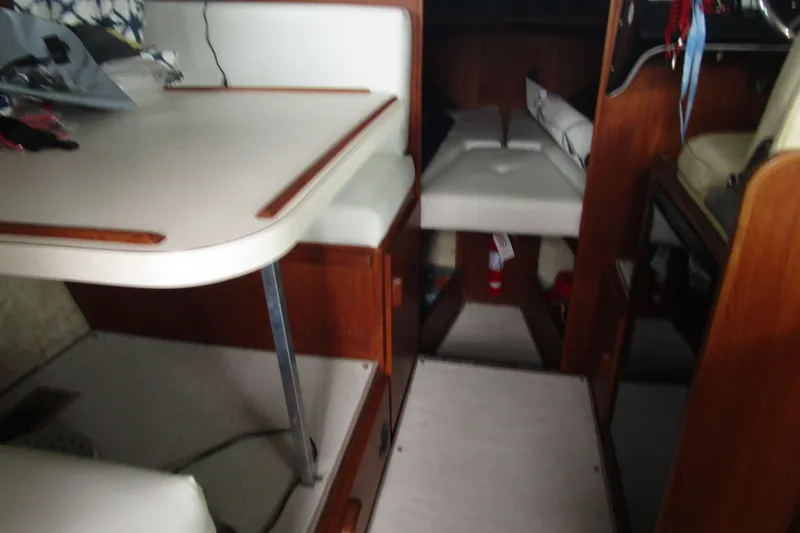 Slide: The Image of Interior of a 1984 Tollycraft 26 Sedan boat with seating and table. - 23