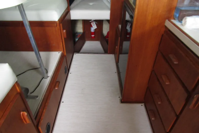 Slide: The Image of 1984 Tollycraft 26 Sedan interior with wooden cabinetry and seating. - 24