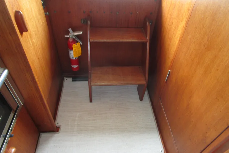 Slide: The Image of Interior of 1984 Tollycraft 26 Sedan with wooden steps and fire extinguisher. - 25