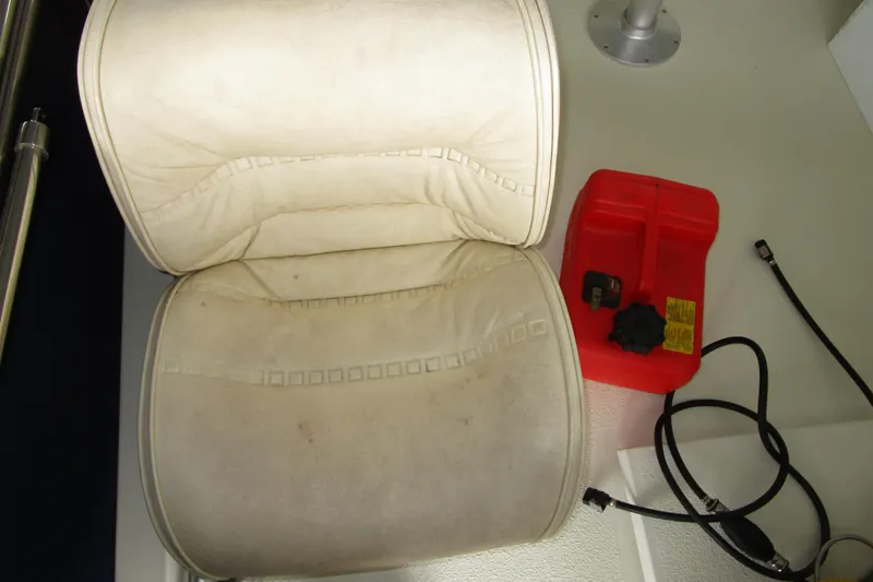 Slide: The Image of White boat seat and red fuel container on 1984 Tollycraft 26 Sedan. - 26