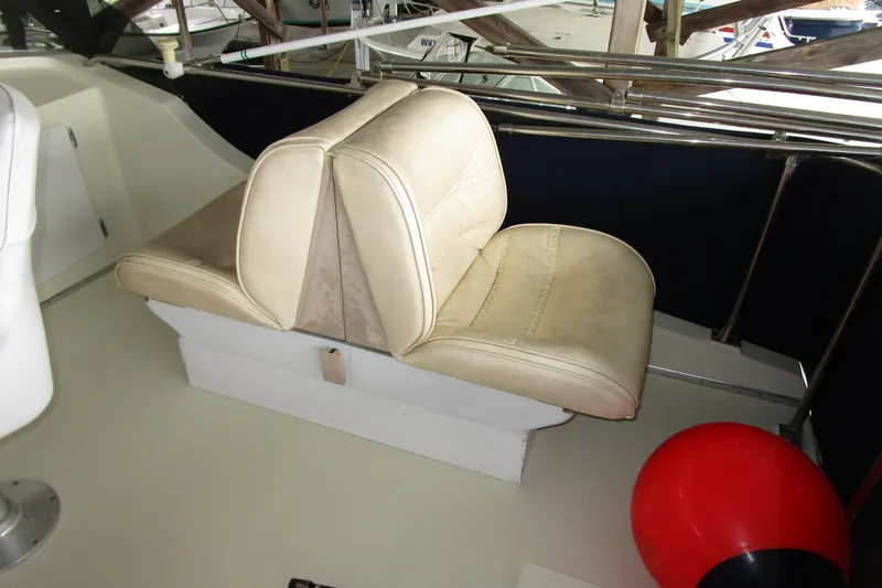 Slide: The Image of 1984 Tollycraft 26 Sedan boat interior with beige seating and red buoy. - 27