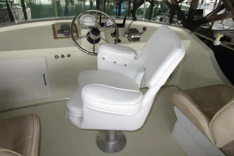 Slide: The Image of Captain's chair and helm of 1984 Tollycraft 26 Sedan boat interior. - 28