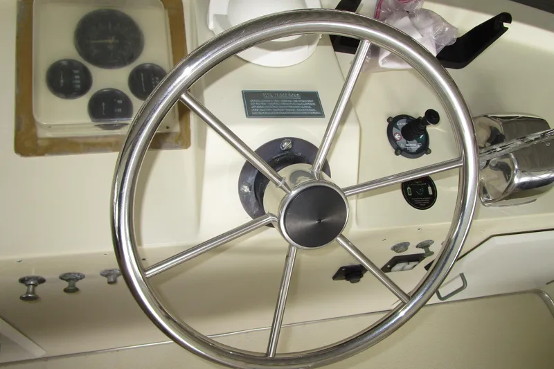 Slide: The Image of Steering wheel of a 1984 Tollycraft 26 Sedan boat with control panel. - 29