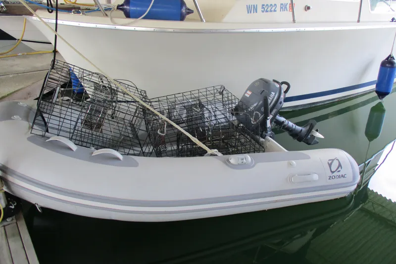 Slide: The Image of Inflatable Zodiac boat with crab traps, docked beside a 1984 Tollycraft 26 Sedan. - 3