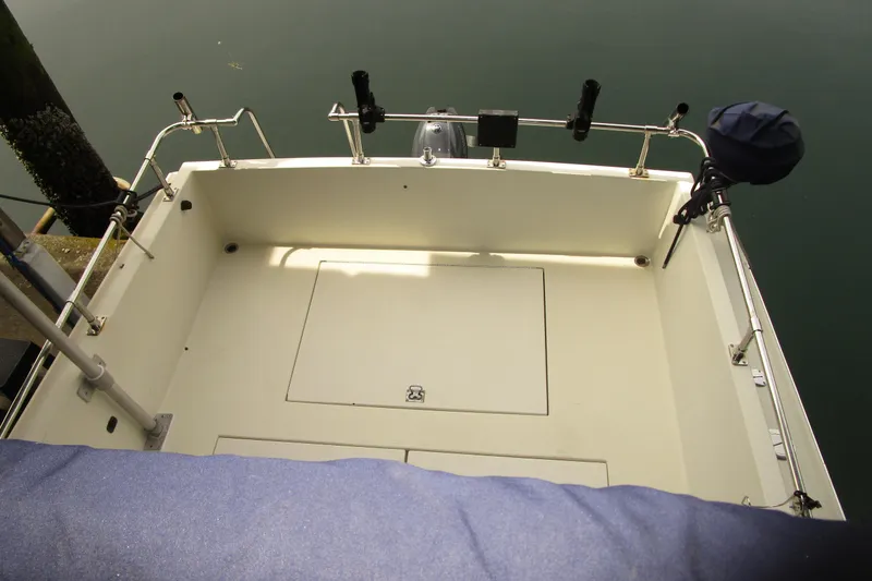 Slide: The Image of 1984 Tollycraft 26 Sedan boat deck with fishing rod holders and storage compartments. - 30