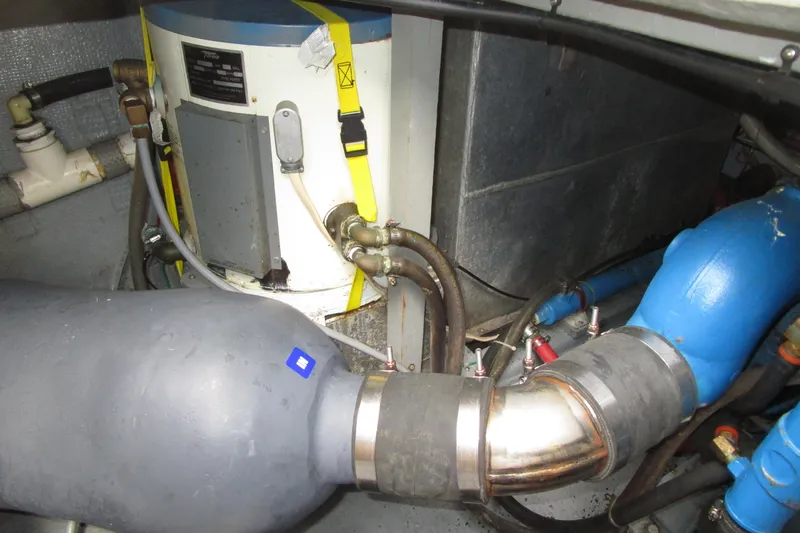 Slide: The Image of Engine room of a 1984 Tollycraft 26 Sedan with visible plumbing and machinery. - 32
