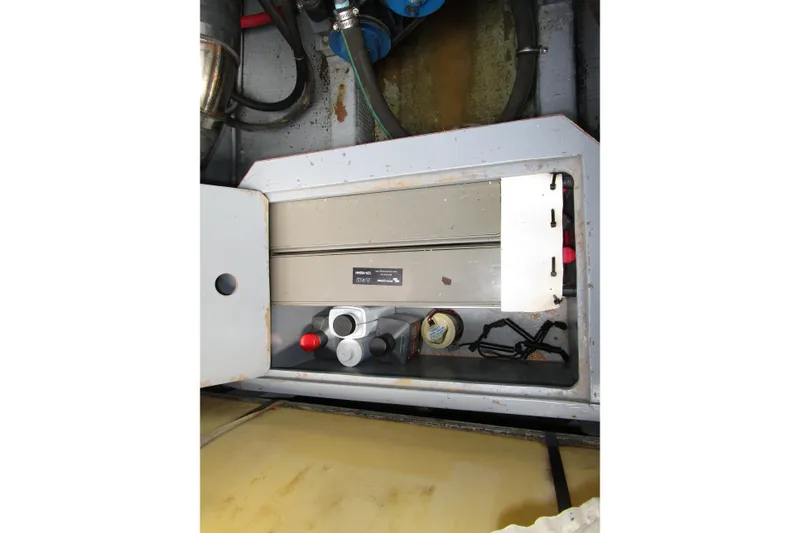 Slide: The Image of 1984 Tollycraft 26 Sedan engine compartment with mechanical components and wiring. - 33
