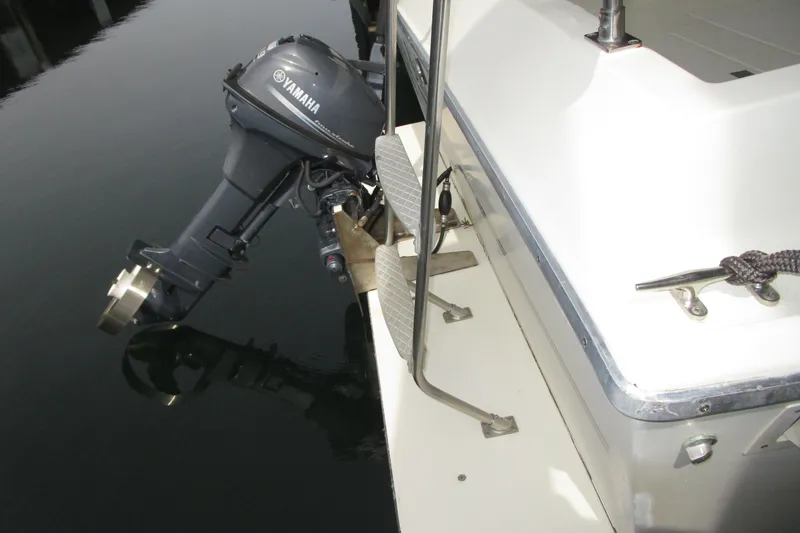 Slide: The Image of 1984 Tollycraft 26 Sedan boat with Yamaha outboard motor on calm water. - 35