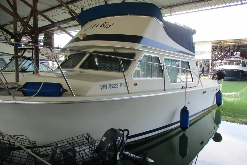 Slide: The Image of 1984 Tollycraft 26 Sedan boat docked in a covered marina. - 4