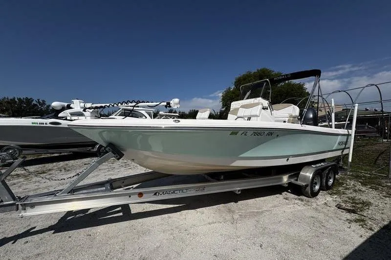 The Image of 2018 Robalo 226 Cayman boat on trailer under clear blue sky. - 0