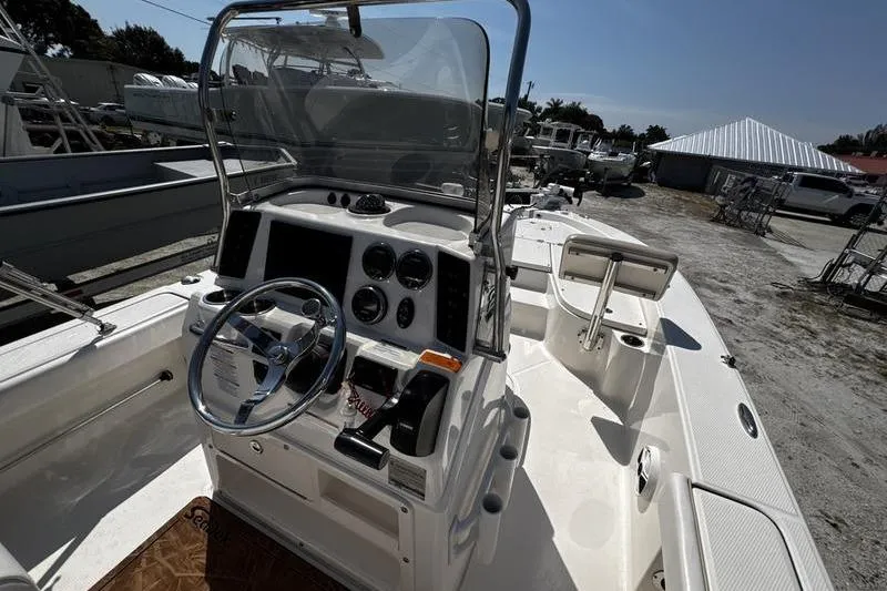 Slide: The Image of 2018 Robalo 226 Cayman boat cockpit with steering wheel and control panel. - 17
