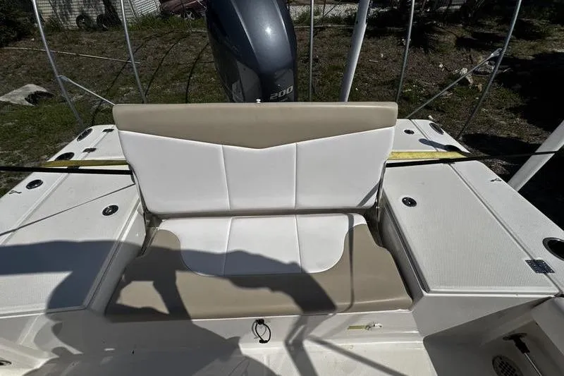 Slide: The Image of 2018 Robalo 226 Cayman boat seating area with engine in background. - 20
