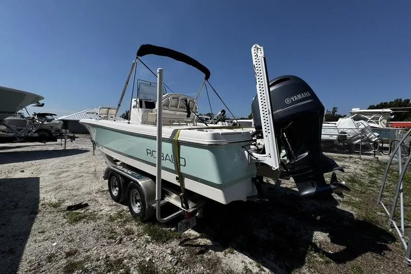 Slide: The Image of 2018 Robalo 226 Cayman boat on trailer with Yamaha outboard motor, parked outdoors. - 3