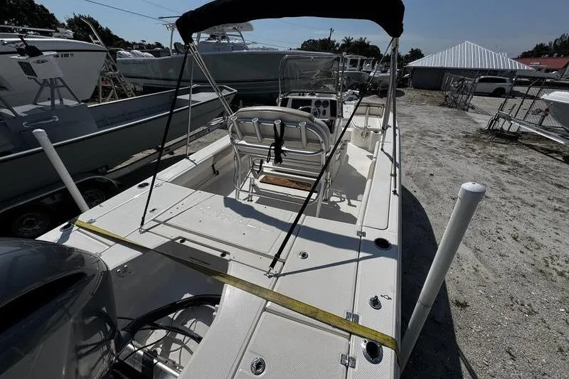 Slide: The Image of 2018 Robalo 226 Cayman boat with center console, parked on a sandy lot. - 6