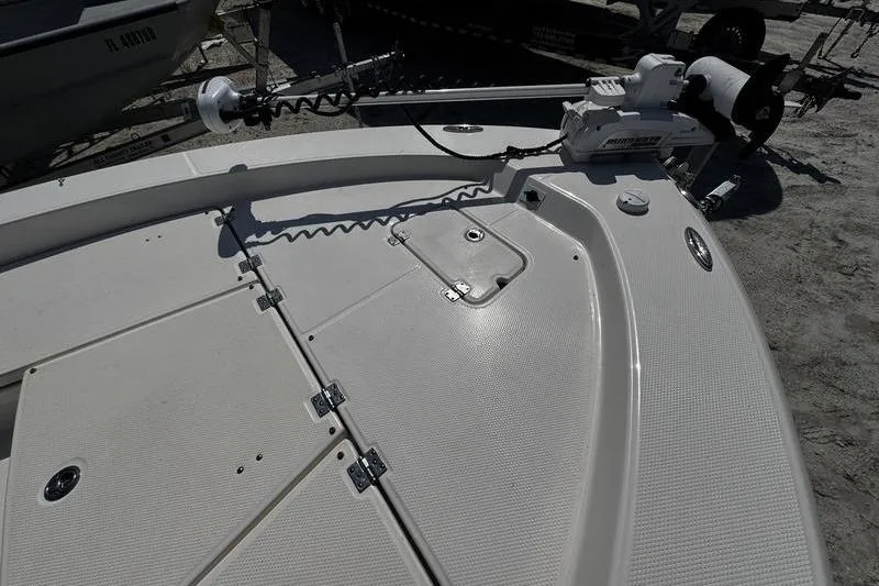 Slide: The Image of 2018 Robalo 226 Cayman boat deck with storage compartments and trolling motor. - 8