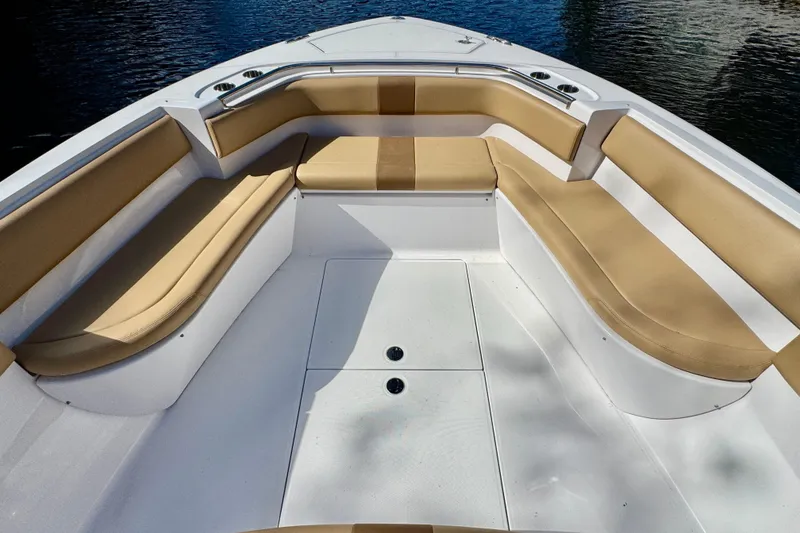 Slide: The Image of Spacious seating area on a 2013 Belzona 32 CC boat with tan cushions. - 14