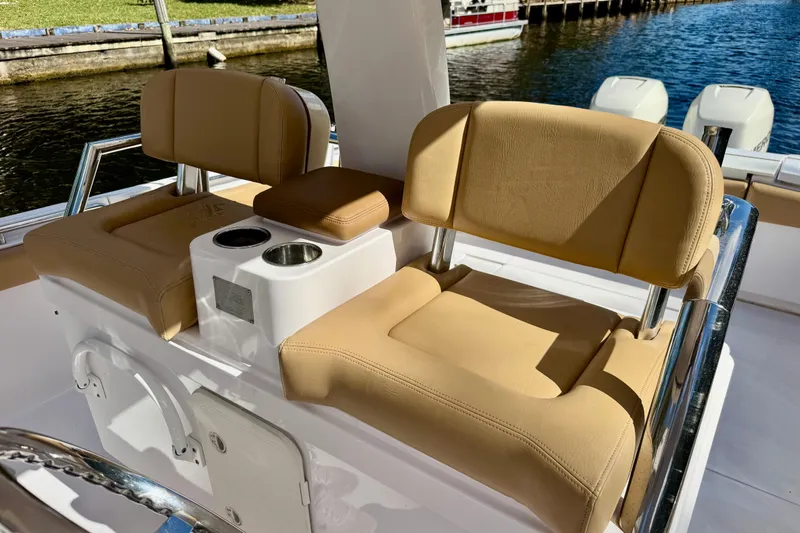 Slide: The Image of 2013 Belzona 32 CC boat interior with tan seating and cup holders. - 20