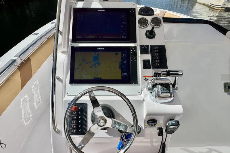 Slide: The Image of Helm of 2013 Belzona 32 CC boat with dual Simrad displays and controls. - 22